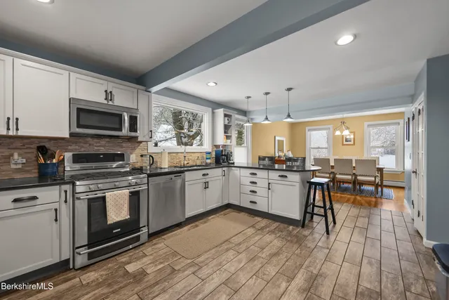 a kitchen with lots of counter top space and stainless steel appliances