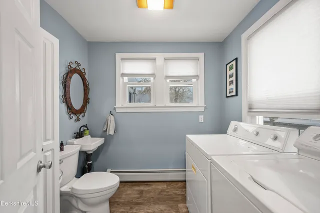 a bathroom with a sink a toilet and a window