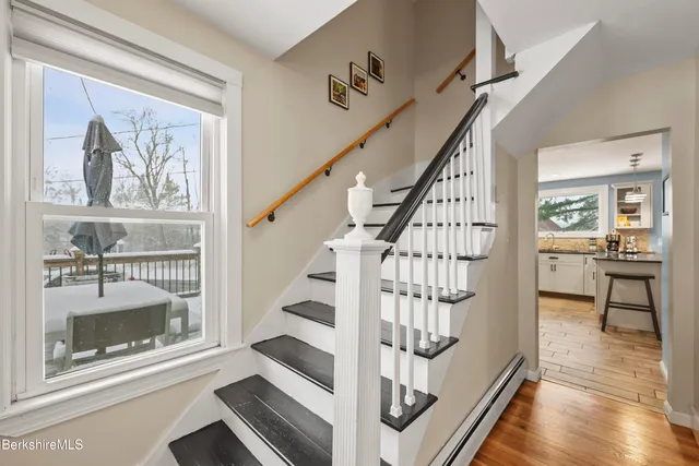 a view of entryway with wooden floor and a front door