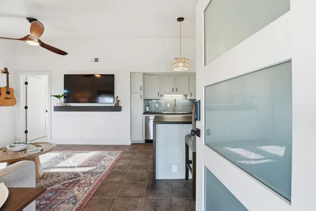 a kitchen with a sink a refrigerator and microwave