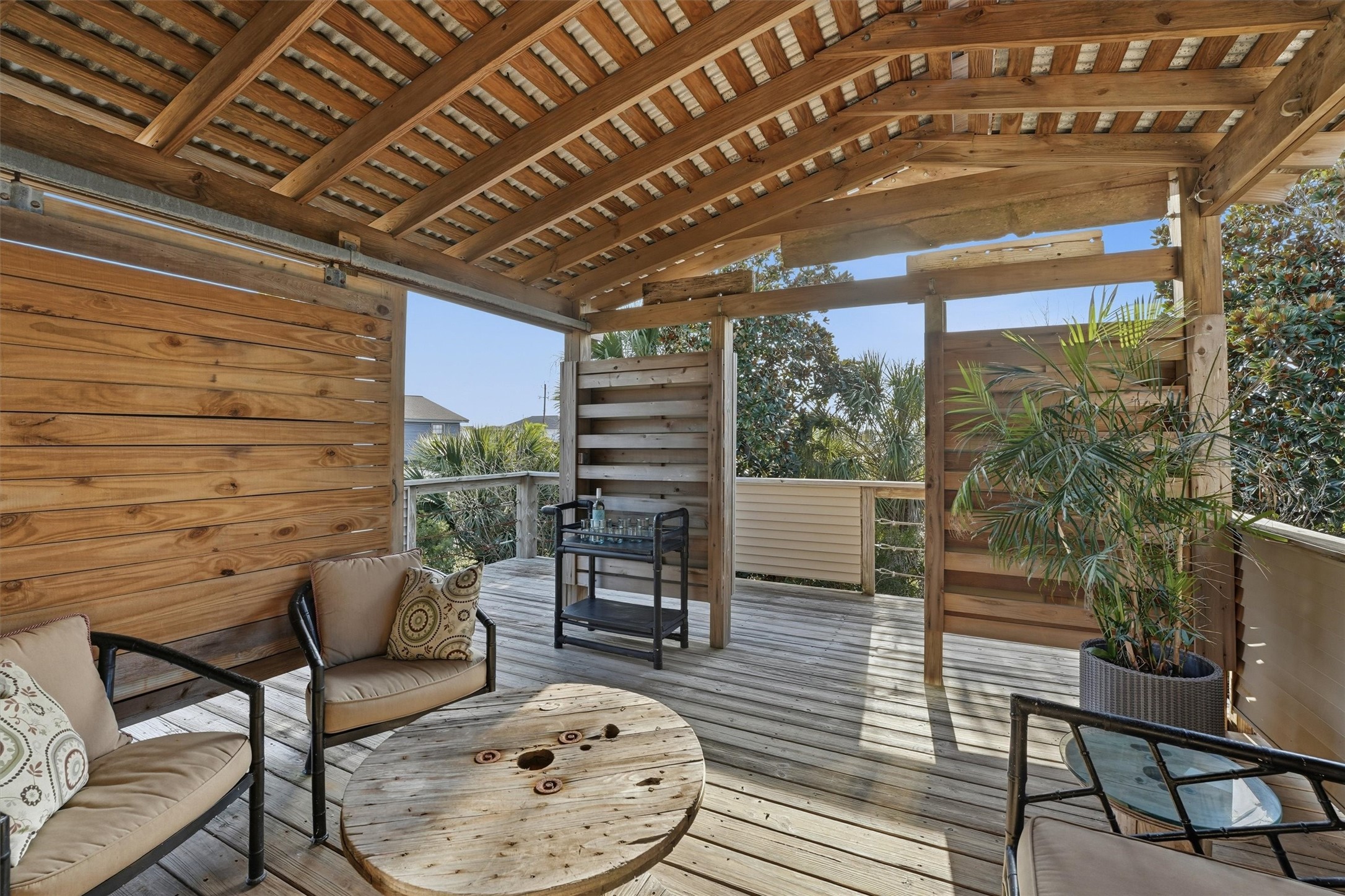 16530 Lewis Scot Road Jamaica Beach, TX 77554 - Photo 13 of 35 Covered private lounge area equipped with a sliding barn door for added seclusion.