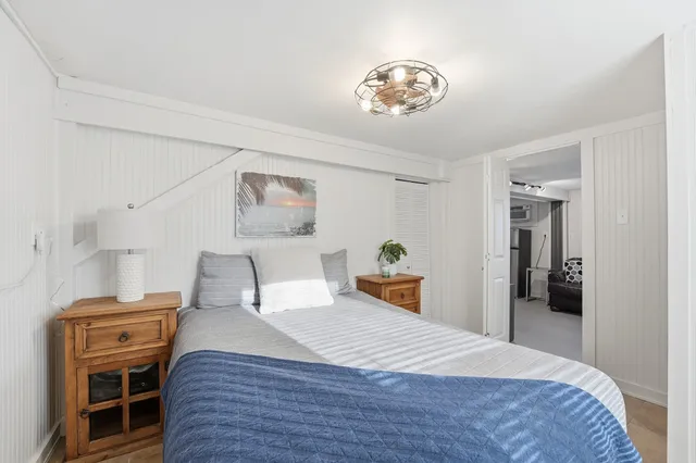 a bedroom with a bed and a chandelier