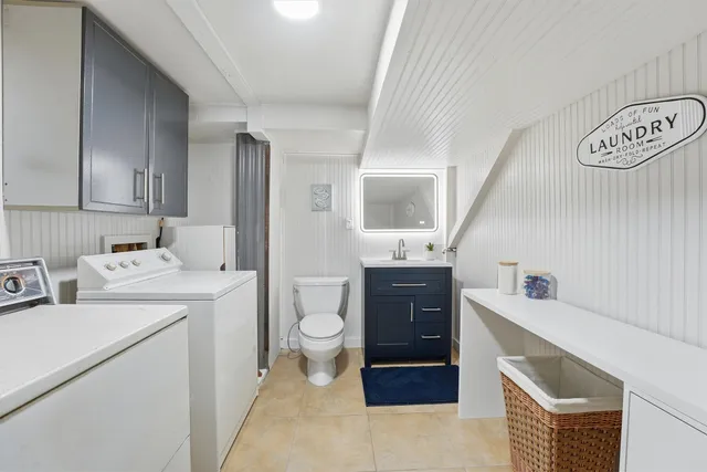 a room with a washing machine and sink