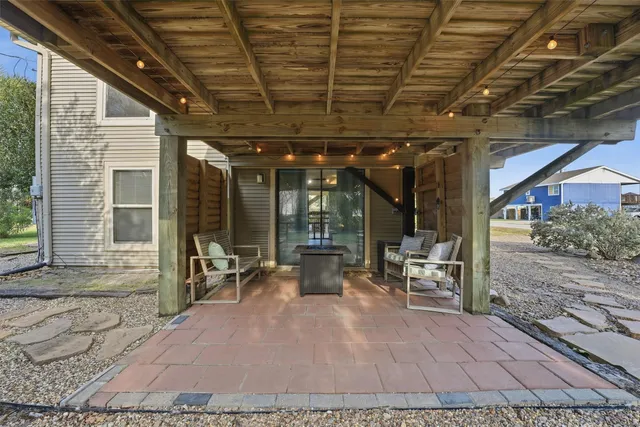 a building outdoor space with patio furniture and garden