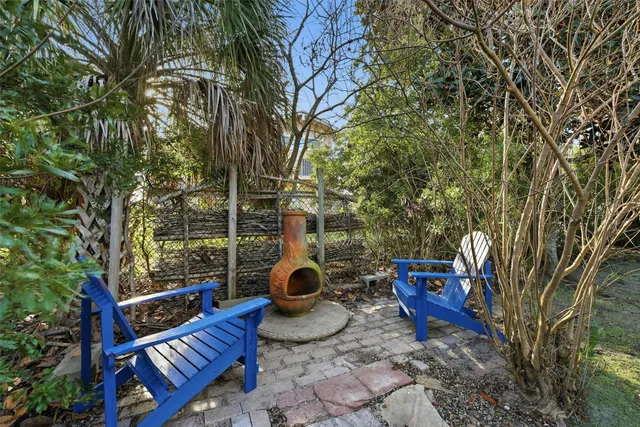 a view of a chairs and fire pit in the backyard