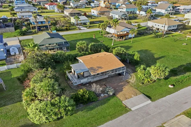 an aerial view of a house with garden space and street view