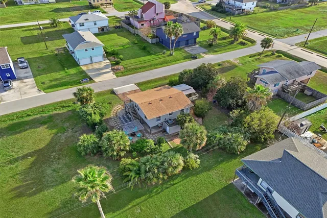 an aerial view of a houses with a yard
