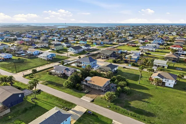 an aerial view of residential houses with outdoor space and river