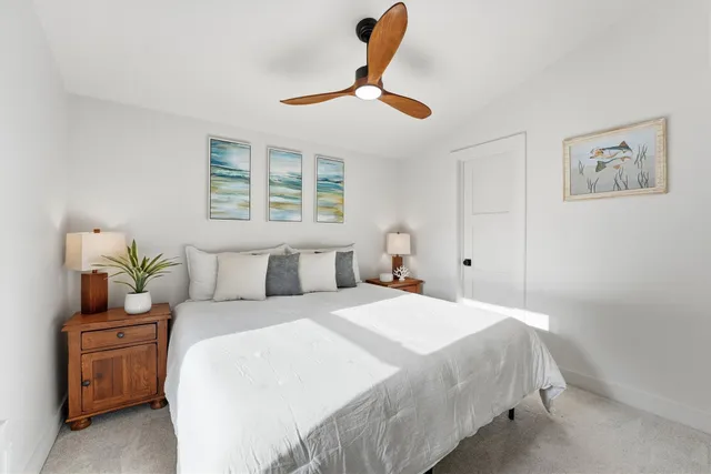 a bedroom with a bed and ceiling fan