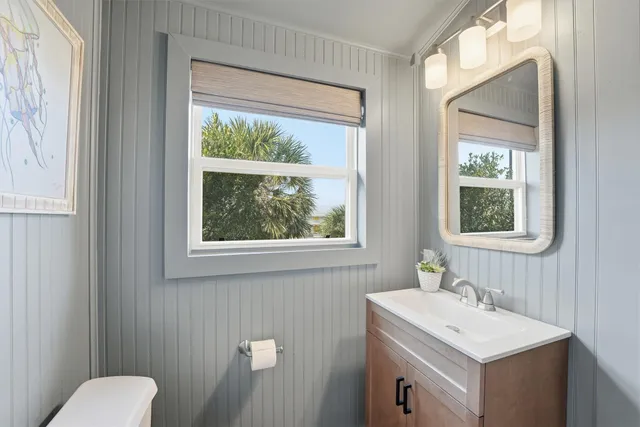 a bathroom with a sink vanity mirror and toilet