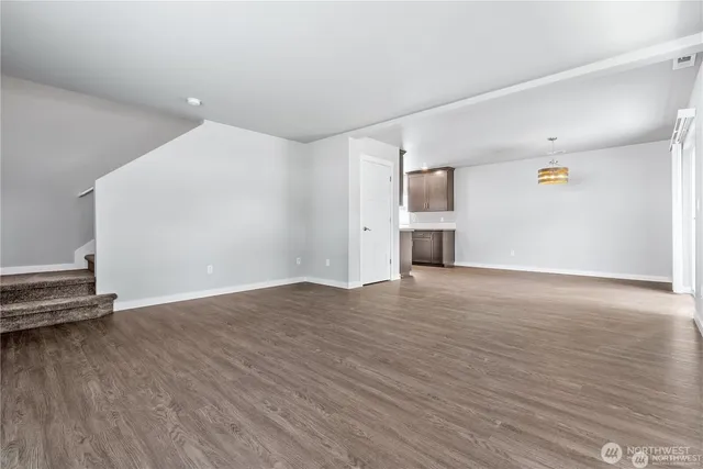 a view of a livingroom with wooden floor and a window