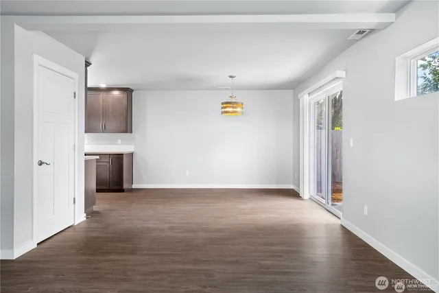 a kitchen with stainless steel appliances sink stove refrigerator and cabinets
