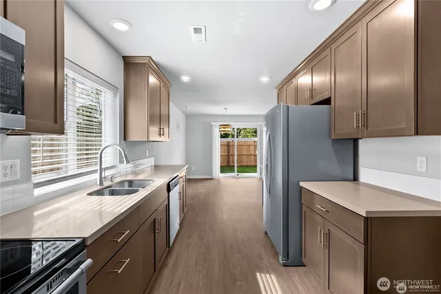 a kitchen with a sink stove and microwave