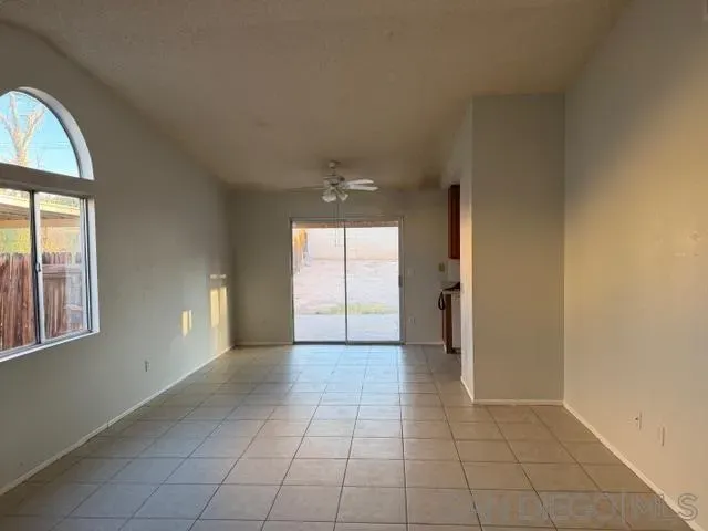 an empty room with windows and entrance