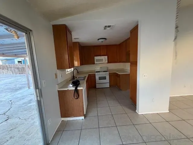 a kitchen with stainless steel appliances a sink stove and cabinets