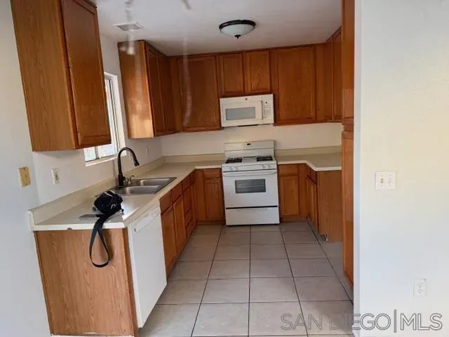 a kitchen with a sink a stove and cabinets