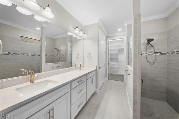 a spacious bathroom with a double vanity sink mirror double and shower