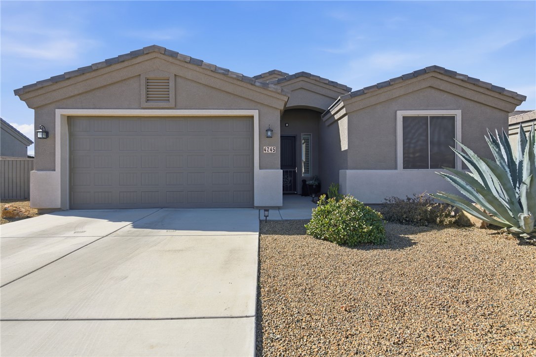 4745 East Old W Road Kingman, AZ 86401 - Photo 1 of 37 Single story home with concrete driveway, a garage, and stucco siding