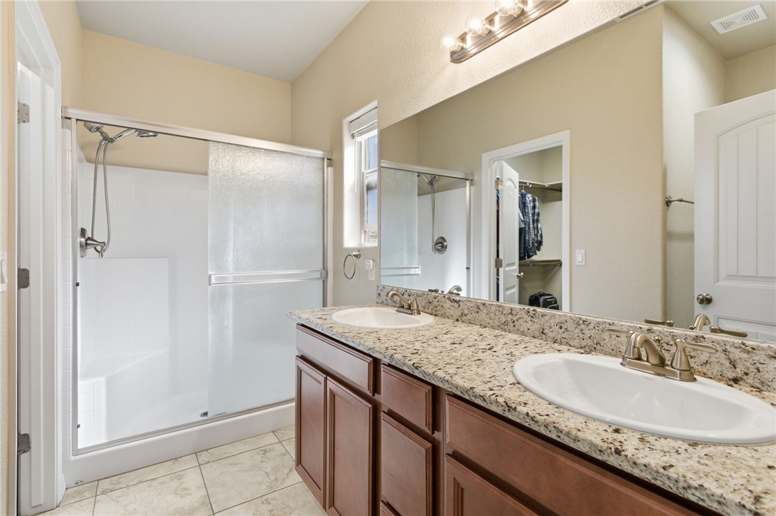 4745 East Old W Road Kingman, AZ 86401 - Photo 17 of 37 Full bath with a walk in closet, double vanity, a stall shower, and light tile patterned flooring