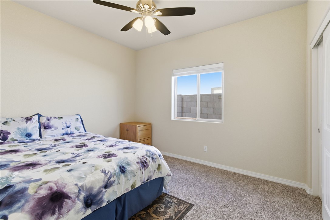 4745 East Old W Road Kingman, AZ 86401 - Photo 19 of 37 Carpeted bedroom featuring a ceiling fan and a closet