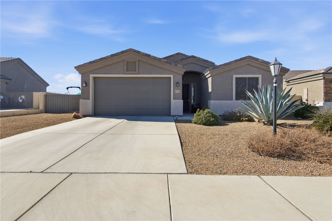 4745 East Old W Road Kingman, AZ 86401 - Photo 2 of 37 Ranch-style house with driveway, a garage, and stucco siding