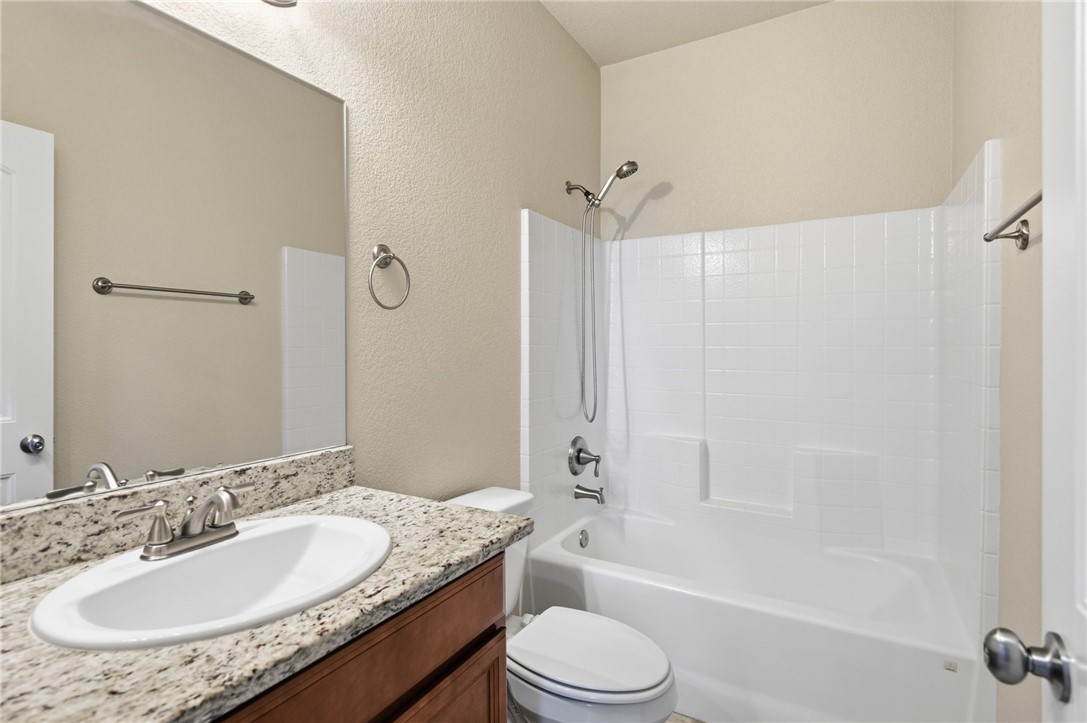 4745 East Old W Road Kingman, AZ 86401 - Photo 21 of 37 Full bath featuring tub / shower combination, vanity, and a textured wall
