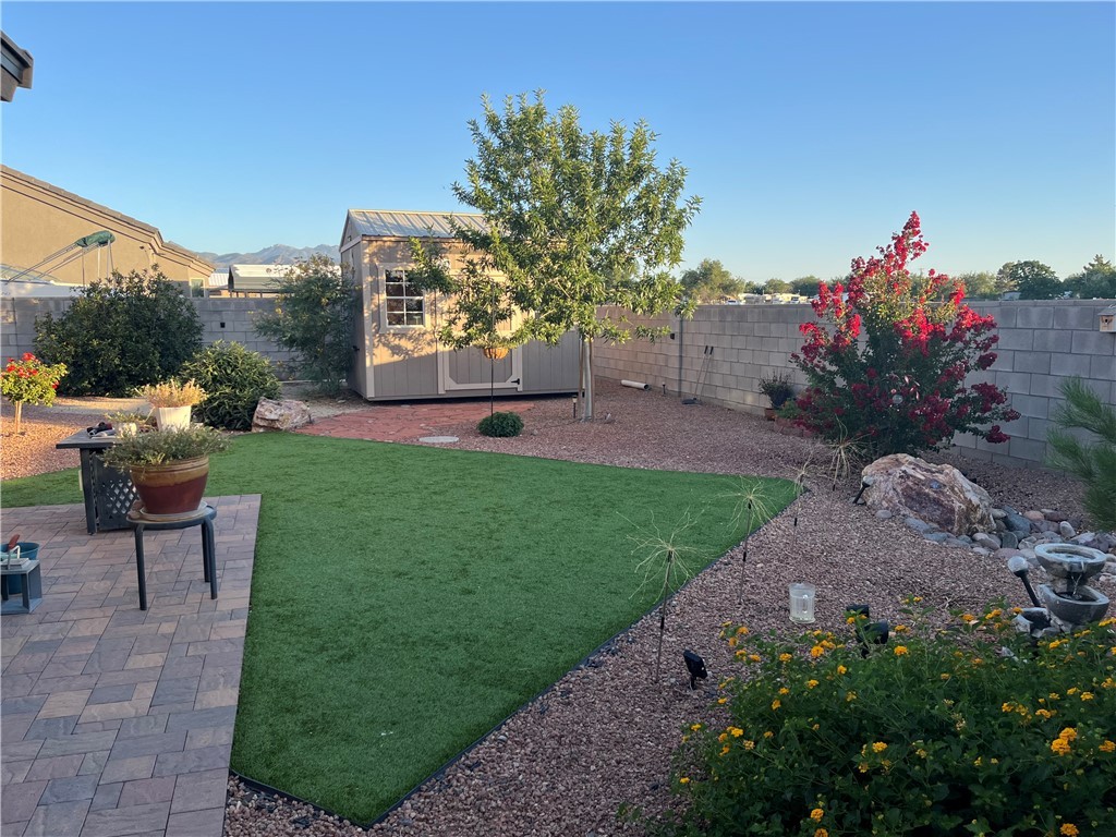 4745 East Old W Road Kingman, AZ 86401 - Photo 28 of 37 Fenced backyard featuring a storage shed and a patio area