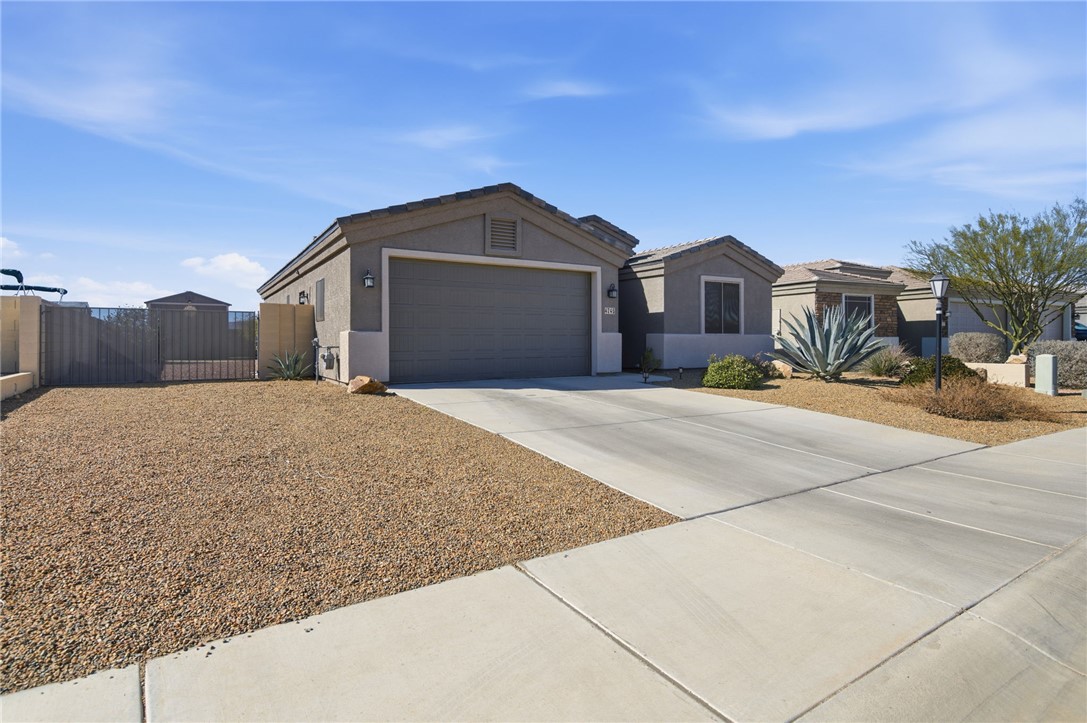 4745 East Old W Road Kingman, AZ 86401 - Photo 3 of 37 Ranch-style house featuring driveway, stucco siding, a gate, and a garage