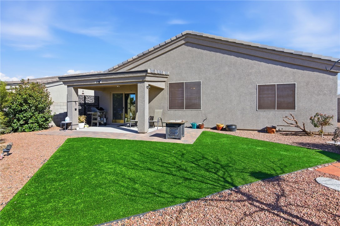 4745 East Old W Road Kingman, AZ 86401 - Photo 31 of 37 Rear view of house featuring a patio, stucco siding, and a yard