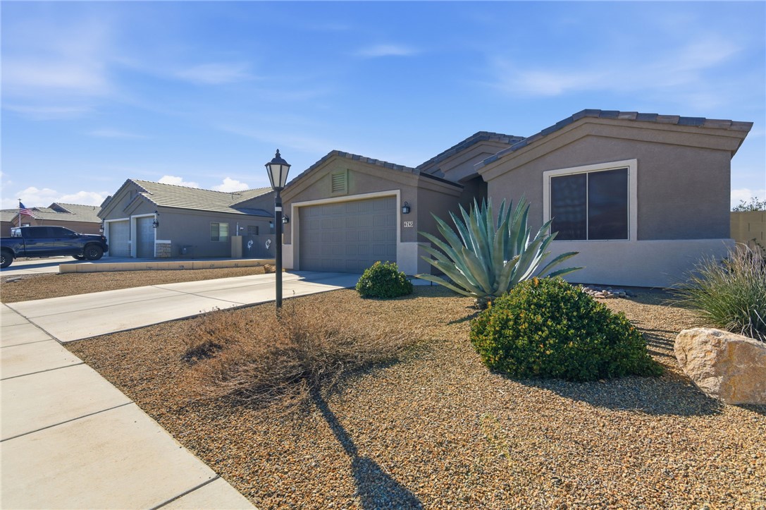 4745 East Old W Road Kingman, AZ 86401 - Photo 4 of 37 Single story home featuring concrete driveway, a garage, and stucco siding
