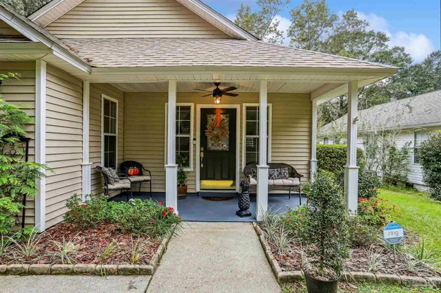 a view of a house with garden and sitting area