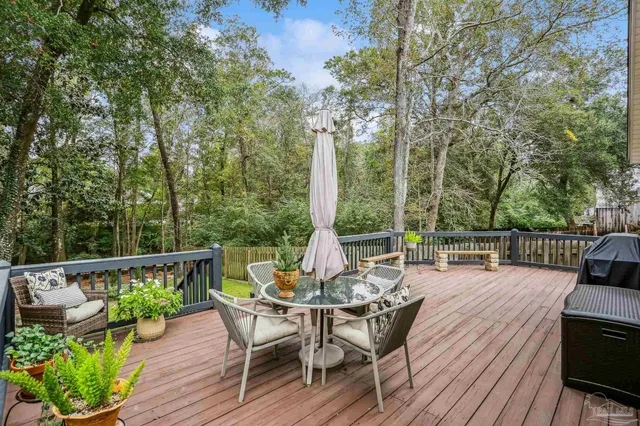 a view of a patio with wooden floor and outdoor seating