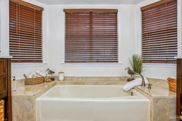 a bathroom with bathtub and window