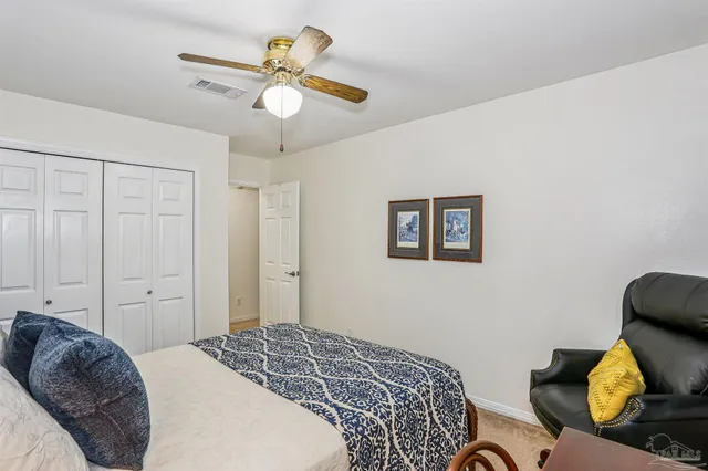 a bedroom with a bed and ceiling fan