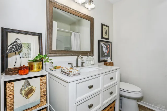 a bathroom with a sink a toilet and mirror