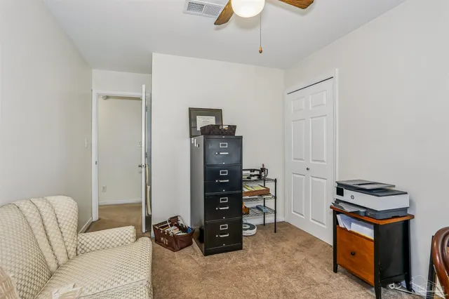 a living room with furniture and a closet