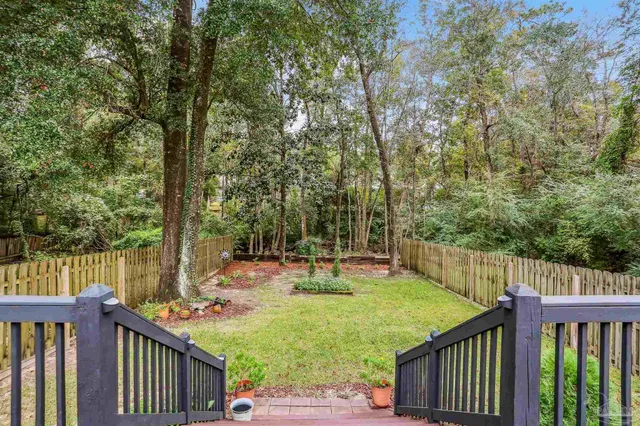 a view of a backyard with a deck and wooden floor