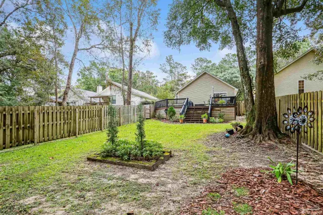 a view of a house with a yard and plants
