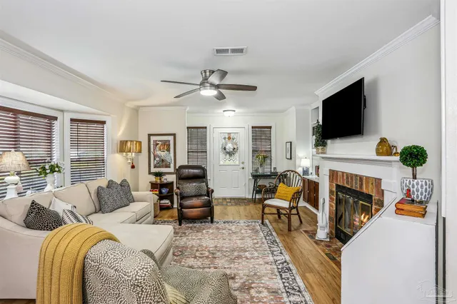 a living room with furniture a flat screen tv and a fireplace