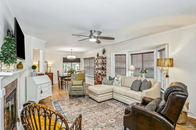 a living room with furniture ceiling fan and a rug