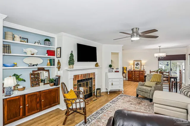 a living room with furniture fireplace and flat screen tv