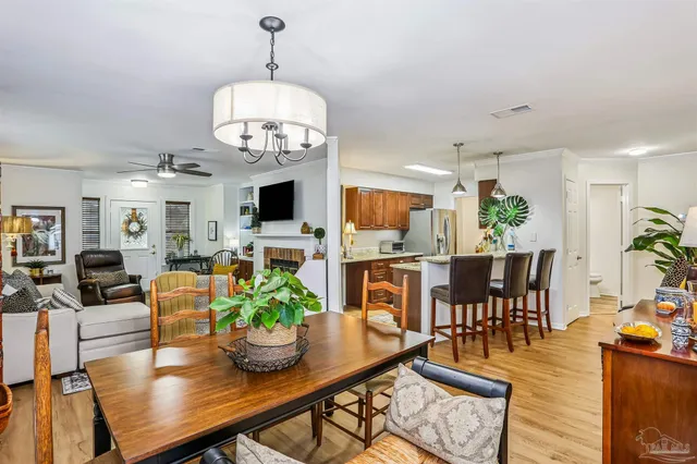 a view of a dining room with furniture a rug and wooden floor