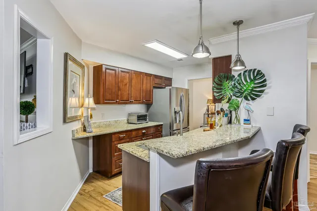 a kitchen with kitchen island granite countertop a sink a center island and cabinets