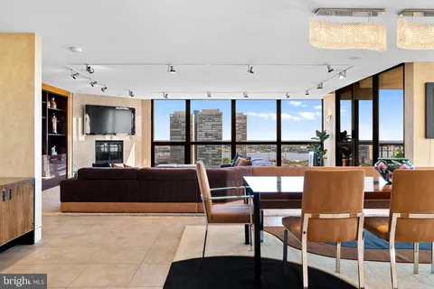 a living room with furniture large window and flat screen tv