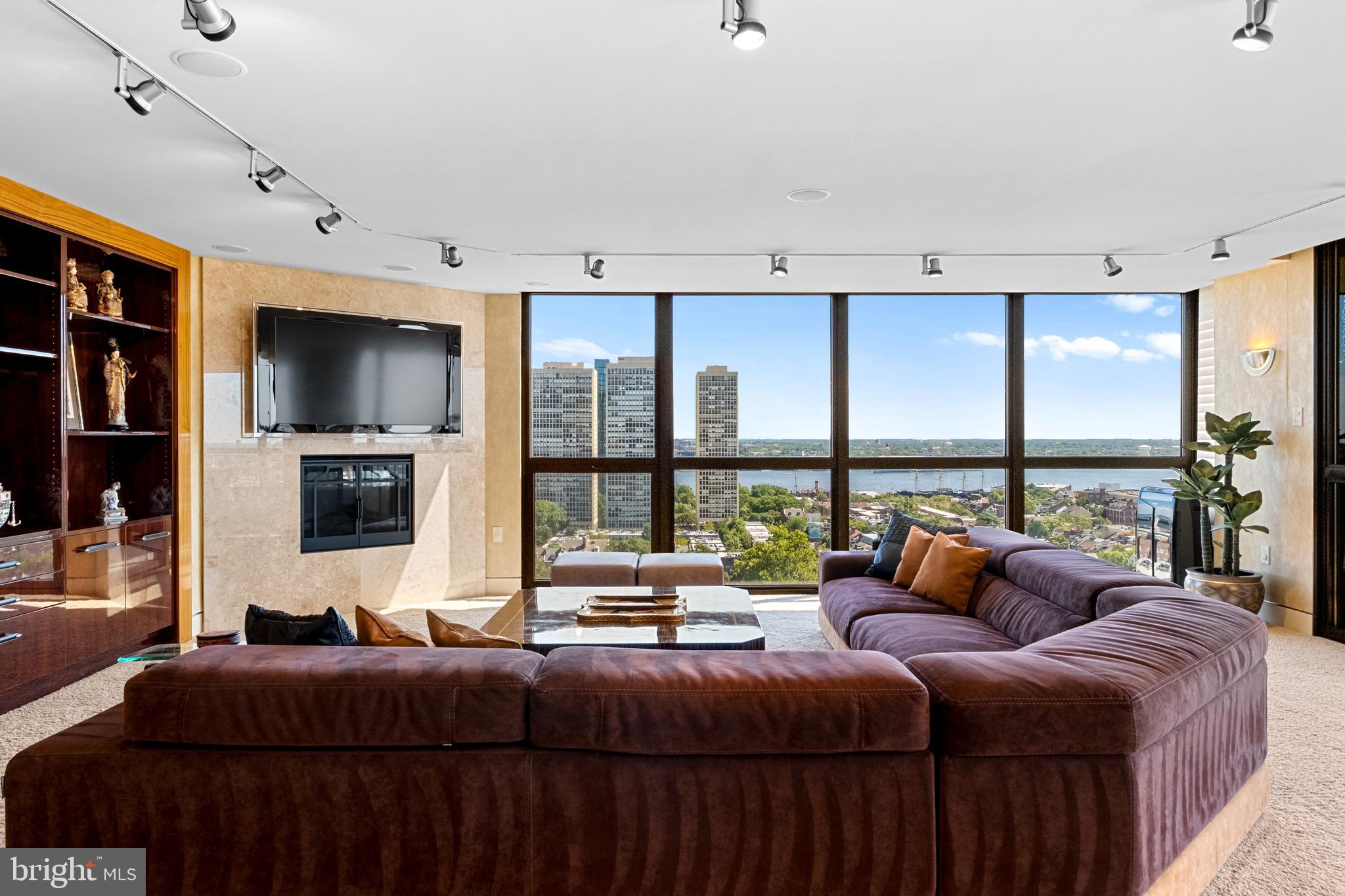 233 South 6th Street, Unit 2009 Philadelphia, PA 19106 - Photo 14 of 55 a living room with a balcony a bed and a large window