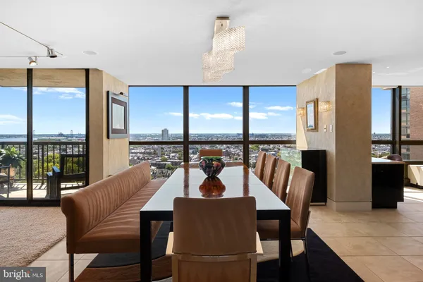 a dining room with furniture a chandelier and wooden floor