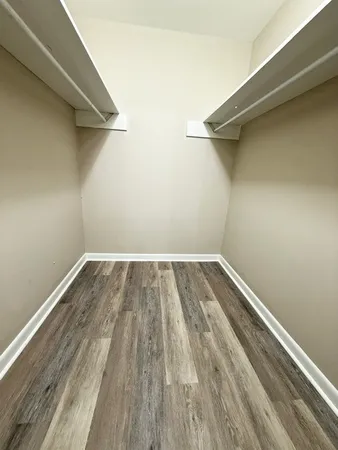 a view of a room with wooden floor and a window
