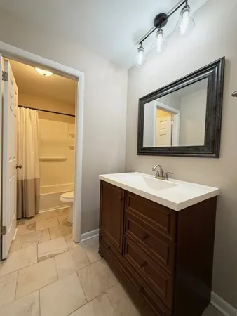 a bathroom with a sink vanity and a mirror