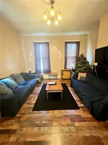 a living room with stainless steel appliances kitchen island granite countertop furniture and a fireplace