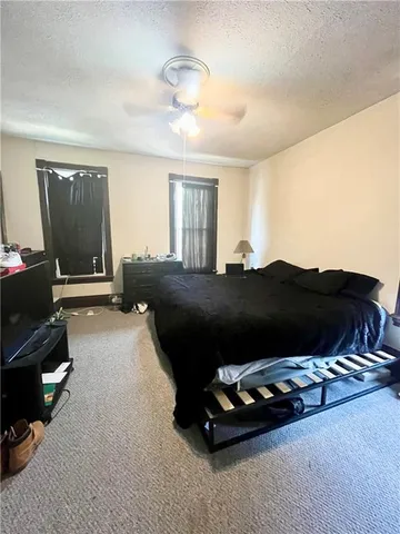 a bed room with a bed and a television